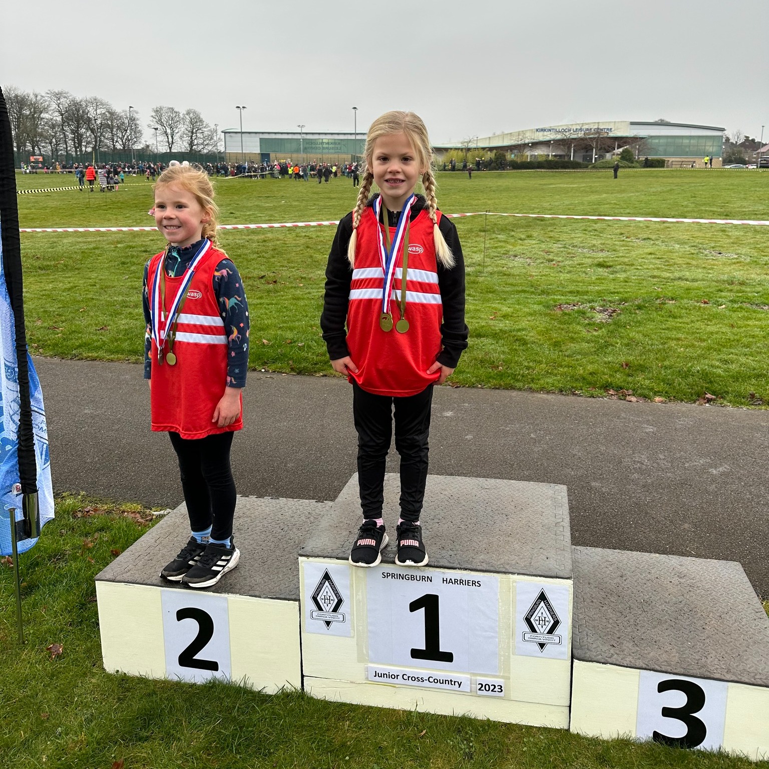 1st Place Lara and 2nd Place Iris on the podium for a Harriers 1-2